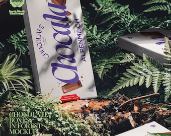 Mockup PSD di confezioni di scatole di cioccolatini in un paesaggio boschivo con felci e tronchi.