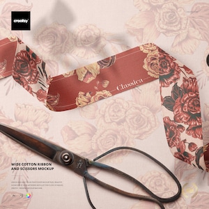 May include: A wide, red cotton ribbon with a floral pattern and the word "Classica" is displayed with vintage scissors. The ribbon features a design of red and gold roses. The scissors are dark metal.