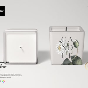May include: A frosted glass candle jar mockup set with a white background. The jar is square and has a white lid. The jar is empty, but there is a wick in the center. The jar is surrounded by a white background.