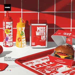 May include: A fast food branding mockup featuring a burger, condiments, and a tray. The burger sits in a red box with the text "FRESH". Ketchup and mustard bottles are visible, along with a napkin holder that reads "MESS WITH US".