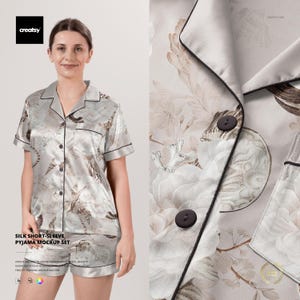 May include: A light gray silk pajama set with a floral pattern and black trim. The set includes a short-sleeved button-down shirt and matching shorts. The text "SILK SHORT-SLEEVE PYJAMA MOCKUP SET" is visible.