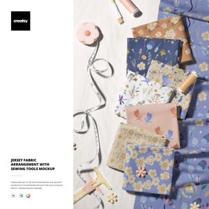 May include: A mockup featuring various floral patterned jersey fabrics, sewing tools, and a measuring tape. The fabrics display a range of colors, including blue, peach, and cream. The image also includes a pink flower-shaped pin cushion and a pair of pink calipers.