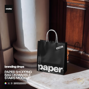 May include: A black paper shopping bag with white handles and the word "paper" in large white letters. The bag has a small white label that says "creatsy". The bag is on a marble surface.