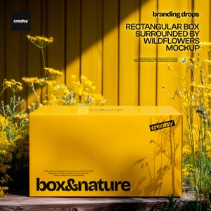 Puede incluir: Una caja rectangular de color amarillo brillante con el texto negro "box & nature" y el logotipo "creatsy". La caja está situada al aire libre, rodeada de flores silvestres amarillas frente a una pared de madera amarilla con el texto "branding drops".