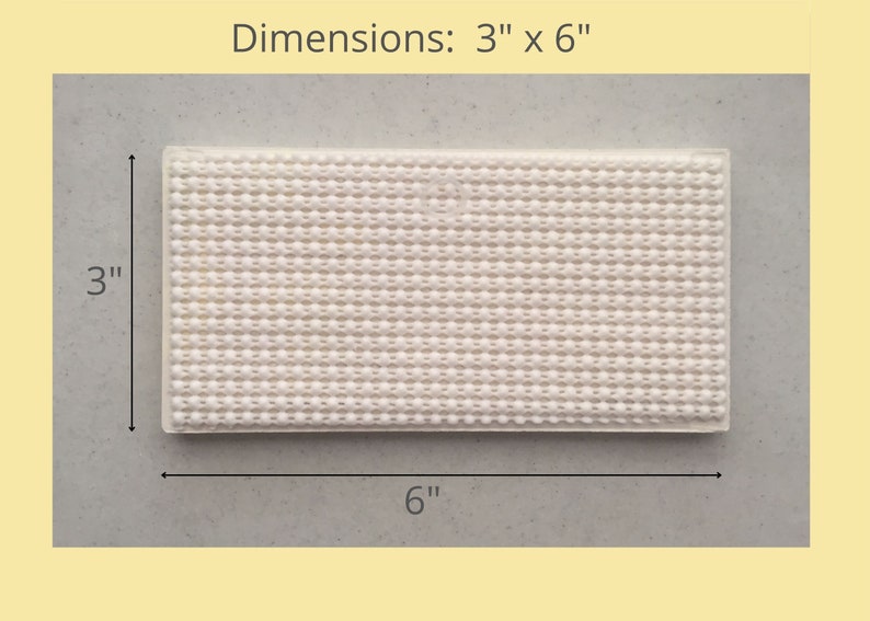 May include: A white, rectangular non-slip mat with a textured surface. The mat measures 3 inches by 6 inches.