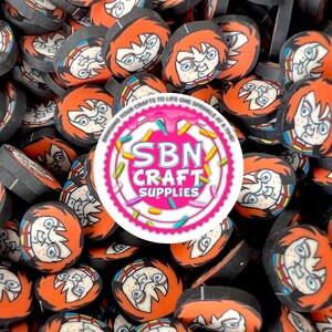 May include: A collection of orange, black, and white polymer clay slices featuring a cartoon character face. The slices are scattered, with a circular logo that reads "SBN CRAFT SUPPLIES" in the center. The logo is surrounded by pink frosting and sprinkles.