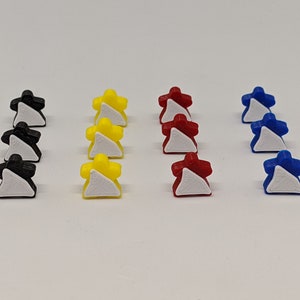 May include: A set of 12 game pieces in four different colours: black, yellow, red, and blue. Each piece is a small, stylised figure with a white triangle on the front.