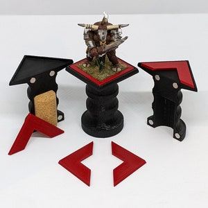May include: A set of black and red magnetic miniature bases for tabletop gaming. The bases are designed to hold miniature figures and have a magnetic system to keep them secure. The set includes a variety of base sizes and shapes.
