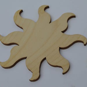 May include: A wooden sun cutout with eight points, ideal for crafting projects.