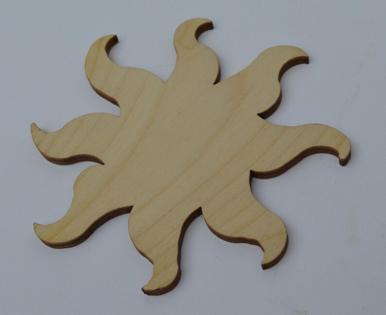 May include: A wooden sun cutout with eight points, ideal for crafting projects.