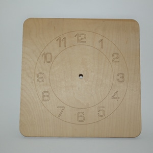 May include: A plain wooden clock face with numbers 1 through 12 printed around the edge.