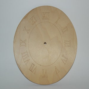 May include: A plain wooden clock face with Roman numeral markings for each hour. The clock face is light brown and has a hole in the center for the clock hands.
