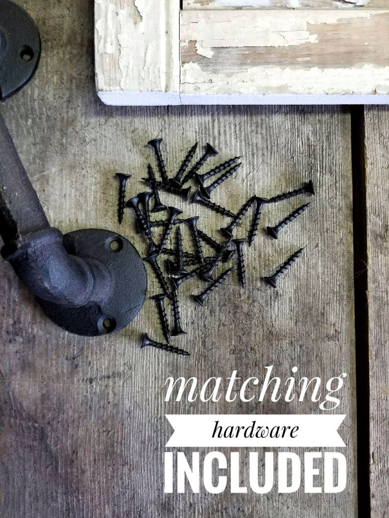 May include: Black metal door handle with matching screws included. The handle is made of pipe and has a rounded end. The screws are scattered on a wooden surface.