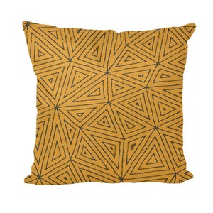 May include: A yellow throw pillow with a black geometric pattern of triangles.