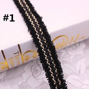 May include: Black and gold trim with a fringe edge. The trim is about 1 inch wide.