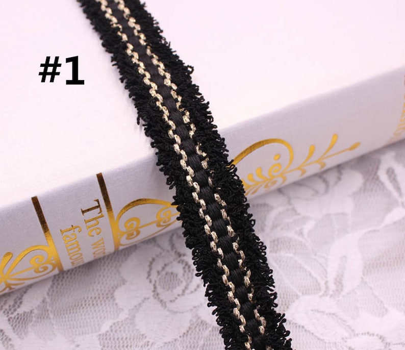 May include: Black and gold trim with a fringe edge. The trim is about 1 inch wide.