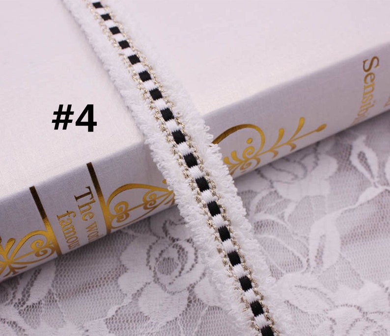 May include: White trim with black and gold stripes. The trim has a fuzzy texture. #4