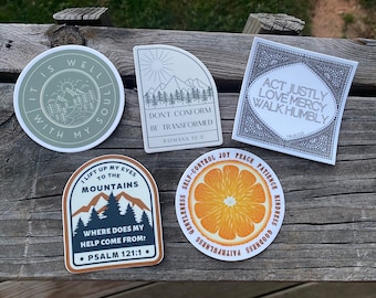 May include: Five different stickers with inspirational quotes and images. The stickers are on a wooden surface. The stickers are all round or oval shaped. The stickers have a white background with black text and images. The stickers are all different sizes. The stickers are all different colors. The stickers are all different designs. The stickers are all different styles. The stickers are all different themes. The stickers are all different messages. The stickers are all different fonts. The stickers are all different sizes. The stickers are all different shapes. The stickers are all different colors. The stickers are all different designs. The stickers are all different styles. The stickers are all different themes. The stickers are all different messages. The stickers are all different fonts.