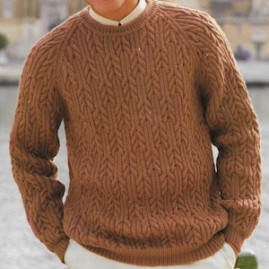 May include: A brown cable knit jumper with a crew neck and long sleeves.