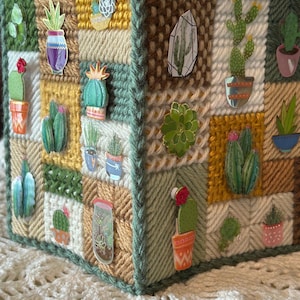 May include: A white ceramic mug with a black handle and the text "But First, Coffee" in a bold, black font. The mug is set against a neutral background, highlighting its simple design.