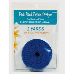 May include: A roll of royal blue 1 inch polypro webbing in clear plastic packaging. The label reads Pink Sand Beach Designs #509, For Bags and Totes, PURSE STRAPPING - ROYAL, 2 YARDS, 1 INCH POLYPRO WEBBING. The packaging features white flower graphics.