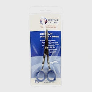 May include: A silver pair of scissors with blue handles, packaged in a clear plastic bag. The packaging features the text "Heritage Cutlery" and "High Quality Scissors & Shears".