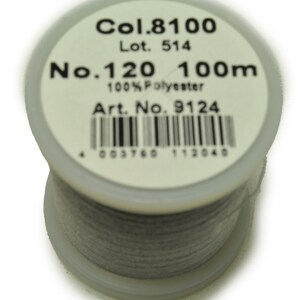 May include: A spool of gray thread labeled "Col. 8100", "Lot. 514", "No. 120 100m", "100% Polyester", "Art. No. 9124", and a barcode with the number "4 003760 112040".