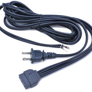 May include: A black power cord with a standard US plug and a female connector. The cord is coiled and has exposed wires at one end. The connectors are black plastic.