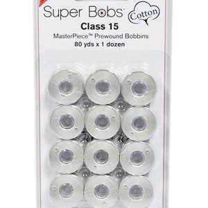 May include: A package of 12 white Super Bobs Class 15 MasterPiece Prewound Bobbins for sewing, each containing 80 yards of thread.