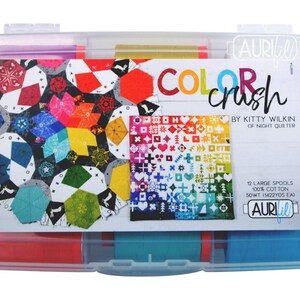 May include: A clear plastic storage case containing 12 spools of Aurifil thread. The spools are labeled "Color Crush" by Kitty Wilkin of Night Quilter. The thread is 100% cotton, 50wt (1422 yds each).
