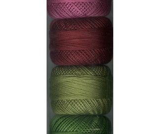 May include: A set of eight spools of embroidery floss in various shades of pink, red, and green. The spools are packaged in clear plastic.