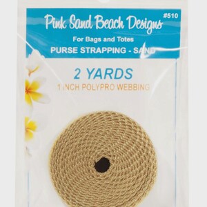 May include: A roll of sand-colored 1-inch polypro webbing measuring 2 yards in length, packaged in a clear plastic bag labeled Pink Sand Beach Designs #510, For Bags and Totes, PURSE STRAPPING - SAND, 2 YARDS, 1 INCH POLYPRO WEBBING.