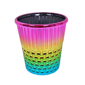 May include: A rainbow-colored metal thimble with a textured design. The thimble is made of metal and has a shiny finish.