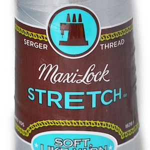 Peut inclure: Une bobine de fil à coudre Maxi-Lock Stretch gris argenté. L'étiquette indique "Soft, Like Yarn" et "Textured Nylon".
