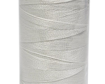 May include: A spool of white thread in a clear plastic container with a black lid.
