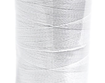 May include: A spool of white thread in a clear plastic container with a black lid.
