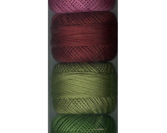 May include: A set of six spools of embroidery floss in shades of pink, red, and green. The spools are arranged vertically in a clear plastic bag.