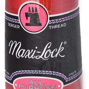 May include: A spool of red Maxi-Lock serger thread, labelled "All Purpose Spun Polyester" and "2742 M".