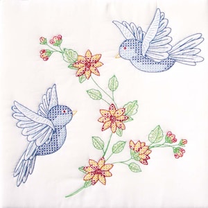 May include: Embroidered design featuring two blue birds flying near a branch with yellow and red flowers. The design is stitched on a white fabric.