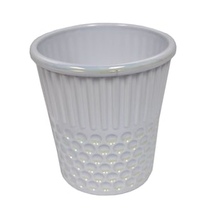 May include: A white ceramic thimble with a textured, circular pattern. The thimble has a smooth, white interior and a slightly iridescent rim.