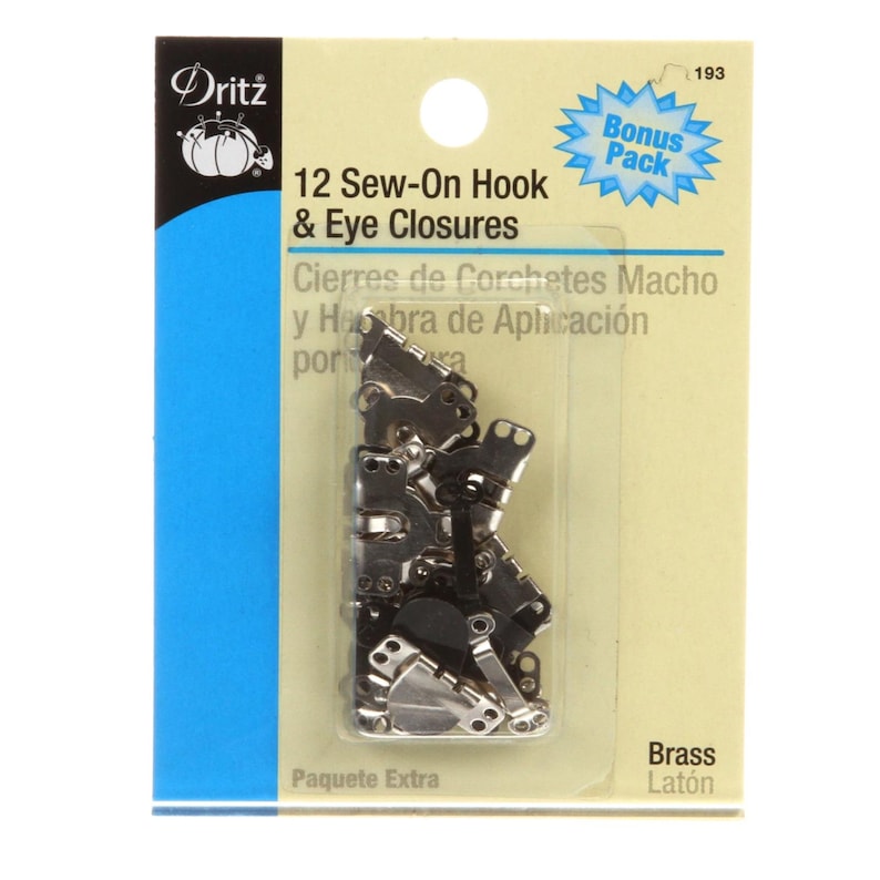 May include: A package of 12 sew-on hook and eye closures. The package has a blue and white design with the brand name "Dritz" at the top. The closures are brass-colored and are in a clear plastic package.