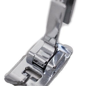 May include: A silver sewing machine foot with a metal shank and a flat base.