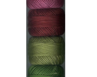 May include: A set of eight spools of embroidery floss in shades of pink, red, and green. The spools are arranged vertically in a clear plastic package.