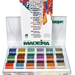 May include: A clear plastic box filled with 18 spools of colorful embroidery thread. The spools are arranged in three rows of six. The box is labeled "MADERA" and "Polyneon".
