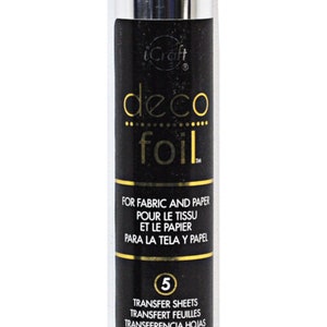 May include: A silver deco foil transfer sheet in a clear plastic tube. The tube has a black label with the text "deco foil" and "FOR FABRIC AND PAPER POUR LE TISSU ET LE PAPIER PARA LA TELA Y PAPEL". The label also includes the number "5" and the text "TRANSFER SHEETS TRANSFERT FEUILLES TRANSFERENCIA HOJAS 6 in x 12 in (15.2 cm x 30.5 cm)"