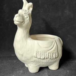 May include: White ceramic llama planter with a detailed face and a small pot on its back.