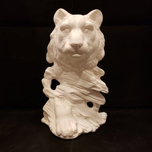 May include: White ceramic figurine of a tiger's head and paw emerging from a rock-like base.