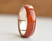 Padauk wood ring with copper inlay on sterling silver core. Can be unique wedding band or a statement wood ring for men and women