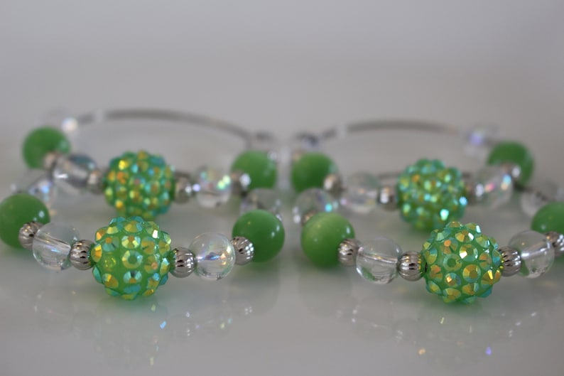 Clear and silver beads add to the look of these fun napkin rings Set of 4. Fun green glass bead napkin rings
