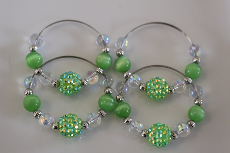 Clear and silver beads add to the look of these fun napkin rings Set of 4. Fun green glass bead napkin rings